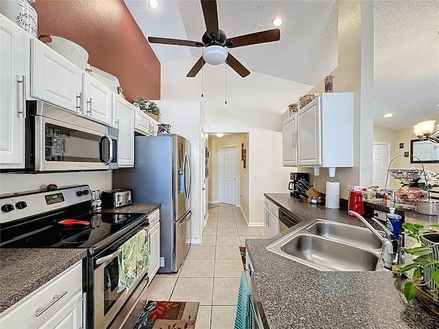 1364 Rebecca Dr, Haines City, FL 33844 - kitchen with stainless steel appliances, dark countertops, a sink, ceiling fan, and light tile patterned flooring