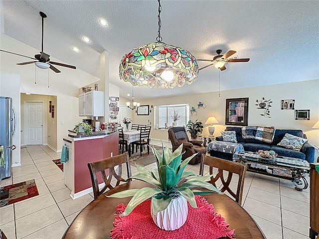 1364 Rebecca Dr, Haines City, FL 33844 - dining room featuring ceiling fan, lofted ceiling, a textured ceiling, light tile patterned flooring, and a chandelier