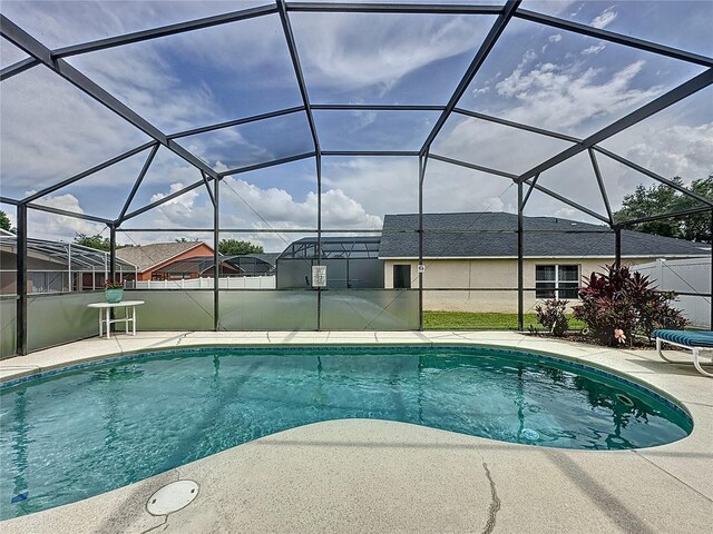 1364 Rebecca Dr, Haines City, FL 33844 - outdoor pool featuring a patio and glass enclosure