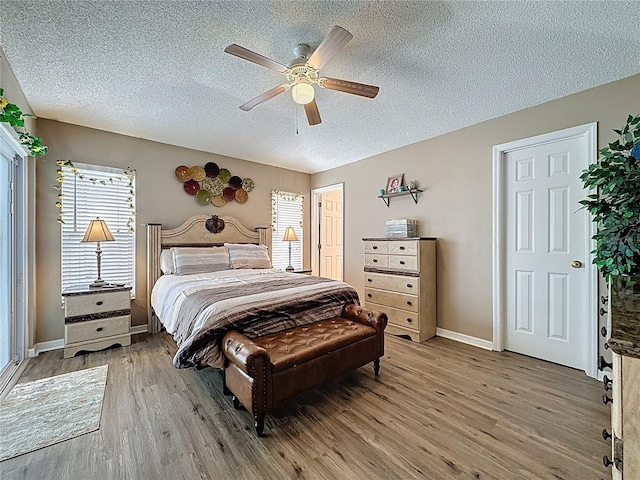 1364 Rebecca Dr, Haines City, FL 33844 - bedroom featuring wood finished floors, a textured ceiling, baseboards, and a ceiling fan