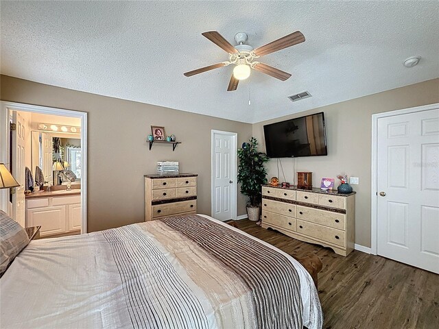 1364 Rebecca Dr, Haines City, FL 33844 - bedroom with wood finished floors, a textured ceiling, baseboards, a ceiling fan, and ensuite bath