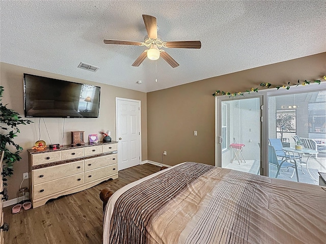 1364 Rebecca Dr, Haines City, FL 33844 - bedroom featuring dark wood-type flooring, a textured ceiling, baseboards, access to outside, and a ceiling fan