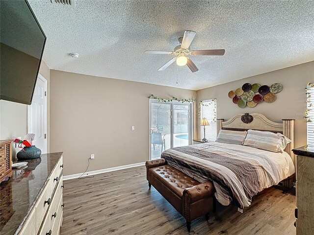 1364 Rebecca Dr, Haines City, FL 33844 - bedroom featuring wood finished floors, a textured ceiling, access to exterior, ceiling fan, and baseboards