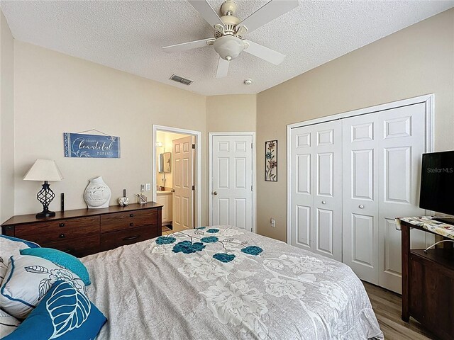 1364 Rebecca Dr, Haines City, FL 33844 - bedroom with wood finished floors, a closet, a textured ceiling, and ceiling fan