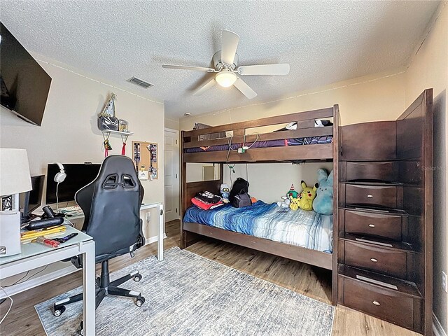1364 Rebecca Dr, Haines City, FL 33844 - bedroom with wood finished floors, a desk, a textured ceiling, and a ceiling fan