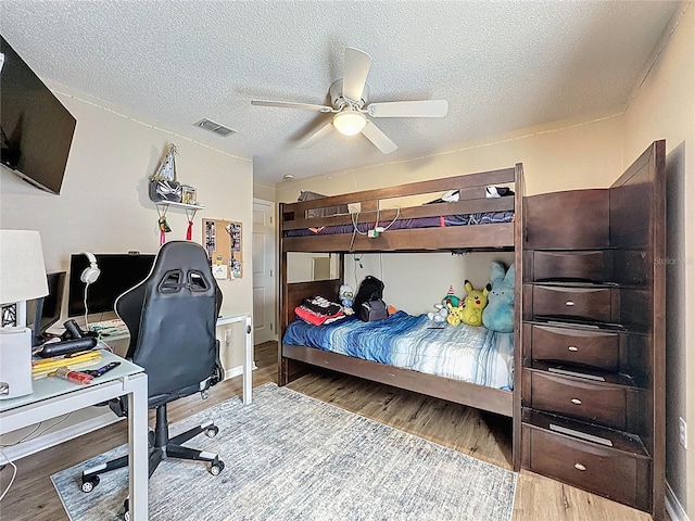 1364 Rebecca Dr, Haines City, FL 33844 - bedroom with wood finished floors, a desk, a textured ceiling, and ceiling fan
