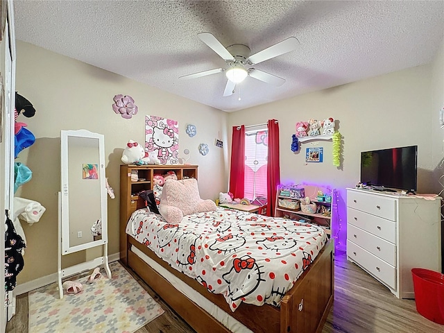 1364 Rebecca Dr, Haines City, FL 33844 - bedroom featuring wood finished floors, ceiling fan, a textured ceiling, and baseboards