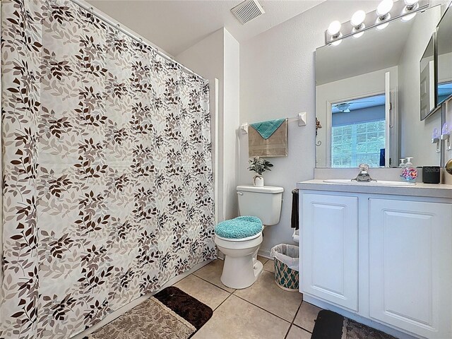 1364 Rebecca Dr, Haines City, FL 33844 - bathroom featuring tile patterned flooring, toilet, vanity, and a shower with shower curtain