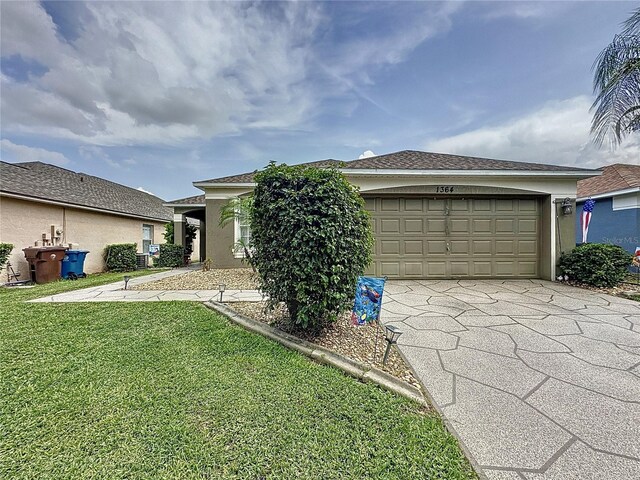 1364 Rebecca Dr, Haines City, FL 33844 - view of front of property featuring concrete driveway, a front lawn, a garage, and stucco siding
