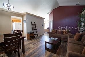 3030 Eagle Crossing Dr, Kissimmee, FL 34746 - living area featuring wood finished floors and vaulted ceiling
