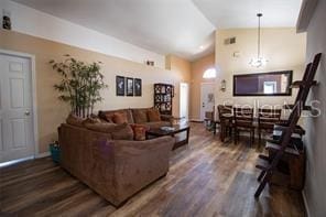 3030 Eagle Crossing Dr, Kissimmee, FL 34746 - living area with vaulted ceiling, wood finished floors, and baseboards