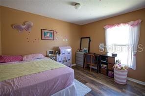 3030 Eagle Crossing Dr, Kissimmee, FL 34746 - bedroom featuring multiple windows, baseboards, and wood finished floors