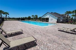 3030 Eagle Crossing Dr, Kissimmee, FL 34746 - community pool featuring a patio area