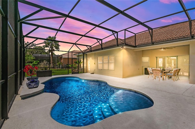 3427 Harborside Ct, Kissimmee, FL 34746 - pool at dusk with an outdoor pool, a patio, ceiling fan, and glass enclosure