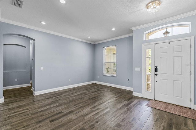 3427 Harborside Ct, Kissimmee, FL 34746 - foyer entrance with arched walkways, dark wood-style floors, crown molding, recessed lighting, and a textured ceiling