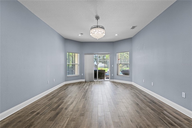 3427 Harborside Ct, Kissimmee, FL 34746 - unfurnished living room featuring dark wood-type flooring, a chandelier, recessed lighting, and a textured ceiling
