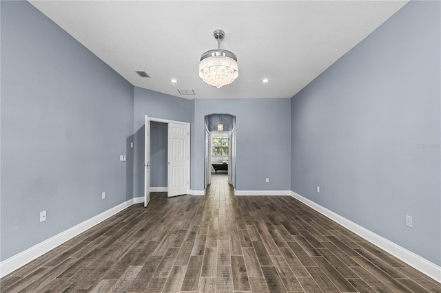 3427 Harborside Ct, Kissimmee, FL 34746 - unfurnished bedroom with a chandelier, dark wood-type flooring, recessed lighting, and arched walkways