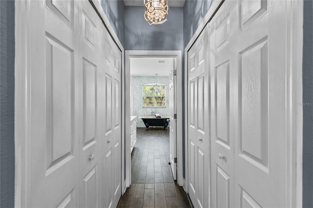 3427 Harborside Ct, Kissimmee, FL 34746 - hallway with a chandelier and dark wood-style floors