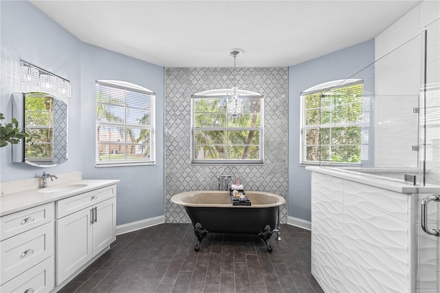 3427 Harborside Ct, Kissimmee, FL 34746 - bathroom featuring vanity, a freestanding bath, an accent wall, wood finished floors, and tile walls