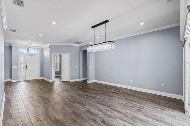 3427 Harborside Ct, Kissimmee, FL 34746 - unfurnished living room featuring dark wood-type flooring, ornamental molding, a chandelier, recessed lighting, and arched walkways