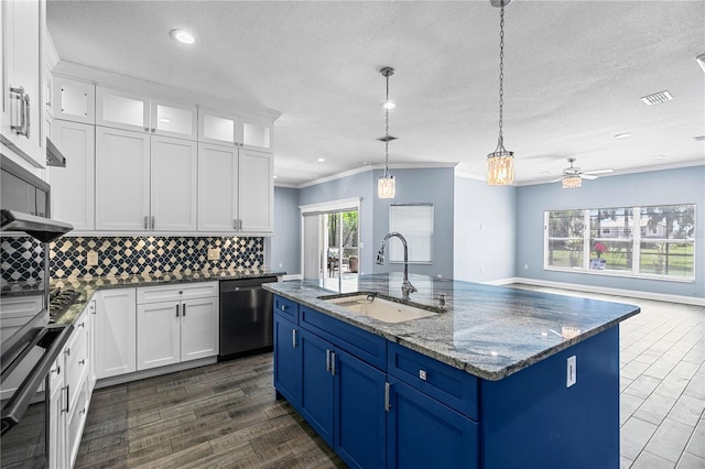 3427 Harborside Ct, Kissimmee, FL 34746 - kitchen featuring stainless steel dishwasher, blue cabinetry, white cabinetry, tasteful backsplash, and a textured ceiling