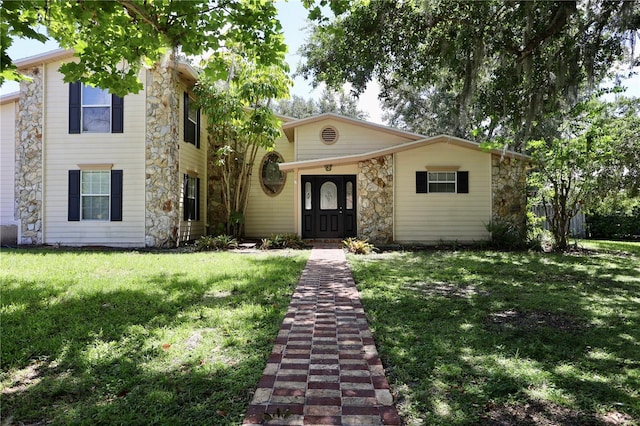 1843 Harbor Blvd, Kissimmee, FL 34744 - view of front of property featuring stone siding and a front yard