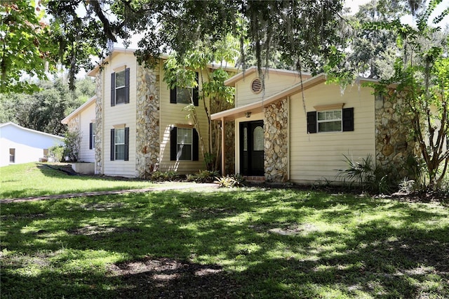 1843 Harbor Blvd, Kissimmee, FL 34744 - view of front of house featuring a front yard and stone siding
