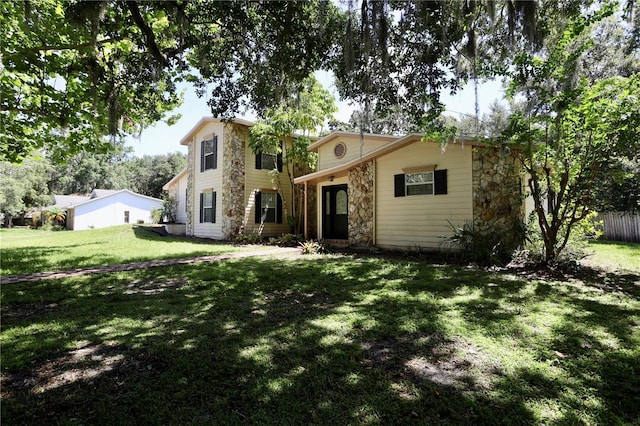 1843 Harbor Blvd, Kissimmee, FL 34744 - view of front of house with stone siding and a front lawn