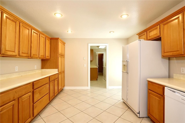 1843 Harbor Blvd, Kissimmee, FL 34744 - kitchen featuring white appliances, light countertops, recessed lighting, light tile patterned floors, and brown cabinets