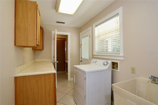 1843 Harbor Blvd, Kissimmee, FL 34744 - laundry area featuring washer / dryer, cabinet space, and light tile patterned flooring