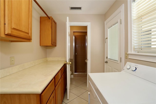 1843 Harbor Blvd, Kissimmee, FL 34744 - laundry area featuring washer / clothes dryer, cabinet space, and light tile patterned flooring