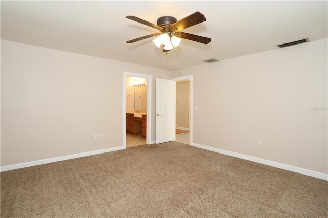 1843 Harbor Blvd, Kissimmee, FL 34744 - unfurnished bedroom featuring light carpet, ensuite bathroom, and ceiling fan