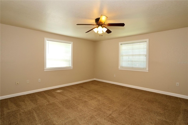 1843 Harbor Blvd, Kissimmee, FL 34744 - empty room with healthy amount of natural light, dark colored carpet, and a ceiling fan
