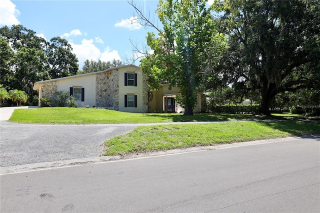 1843 Harbor Blvd, Kissimmee, FL 34744 - view of front of house featuring a front lawn and asphalt driveway