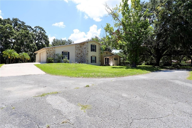 1843 Harbor Blvd, Kissimmee, FL 34744 - view of front facade with concrete driveway, a front yard, and an attached garage
