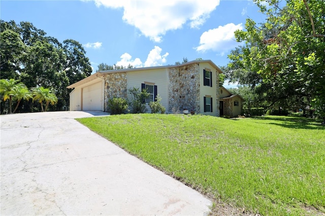 1843 Harbor Blvd, Kissimmee, FL 34744 - view of front of home with stone siding, a front yard, driveway, and a garage