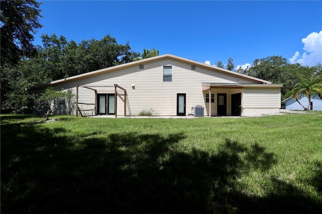 1843 Harbor Blvd, Kissimmee, FL 34744 - rear view of property featuring a yard
