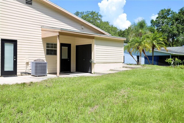 1843 Harbor Blvd, Kissimmee, FL 34744 - rear view of property featuring a yard and a patio area