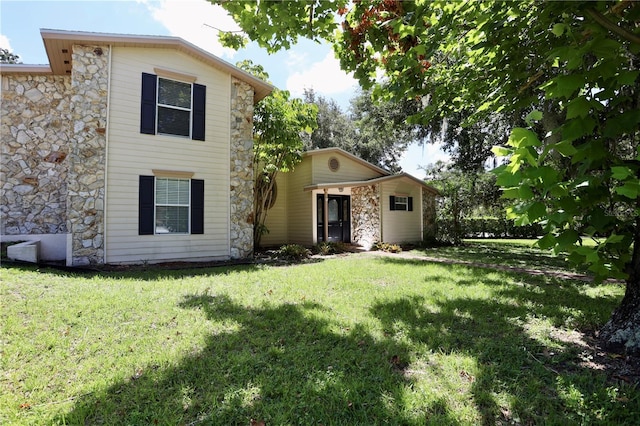 1843 Harbor Blvd, Kissimmee, FL 34744 - view of front of home featuring stone siding and a front lawn