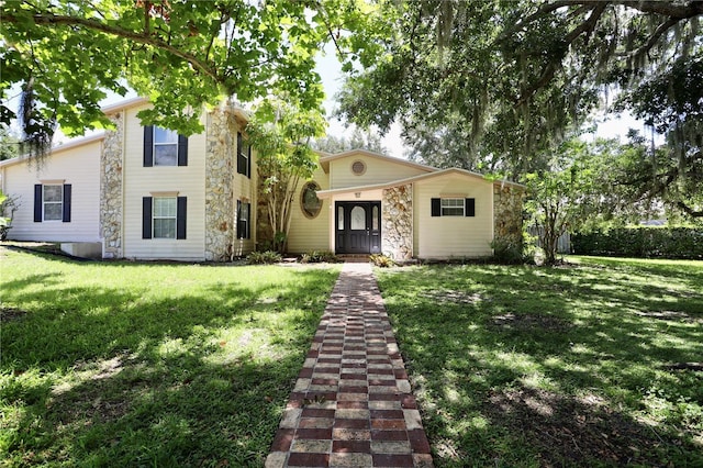 1843 Harbor Blvd, Kissimmee, FL 34744 - view of front of house with stone siding and a front yard