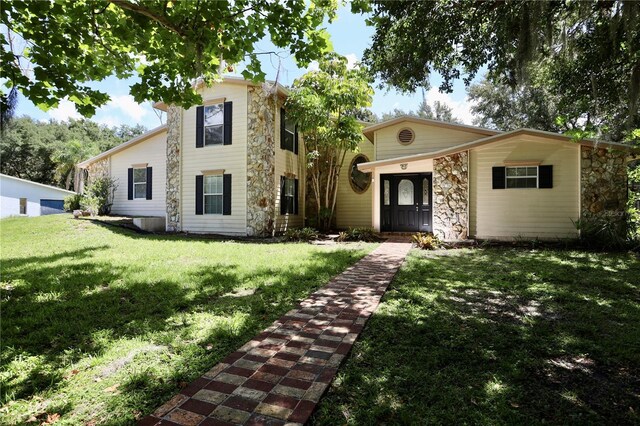 1843 Harbor Blvd, Kissimmee, FL 34744 - view of front of home with a front yard and stone siding