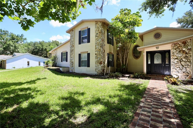 1843 Harbor Blvd, Kissimmee, FL 34744 - view of front of house with stone siding and a front lawn