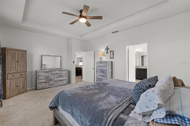 1951 Partin Terrace Rd, Kissimmee, FL 34744 - bedroom featuring a raised ceiling, light carpet, baseboards, connected bathroom, and a ceiling fan