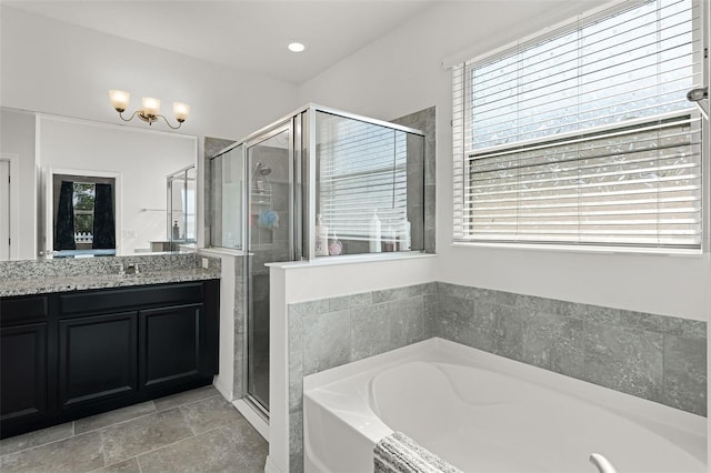 1951 Partin Terrace Rd, Kissimmee, FL 34744 - bathroom with healthy amount of natural light, a garden tub, vanity, and a stall shower
