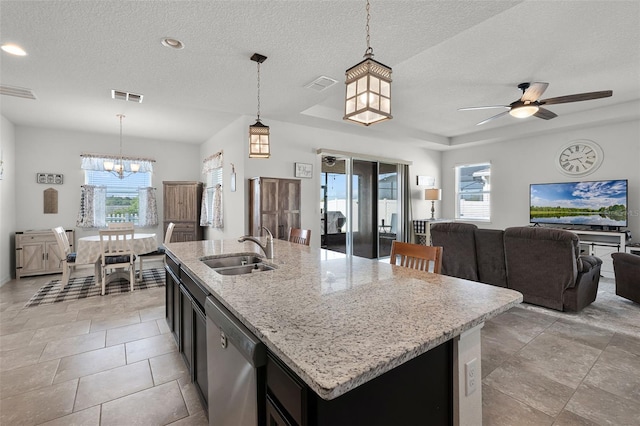 1951 Partin Terrace Rd, Kissimmee, FL 34744 - kitchen featuring a sink, stainless steel dishwasher, healthy amount of natural light, open floor plan, and a textured ceiling