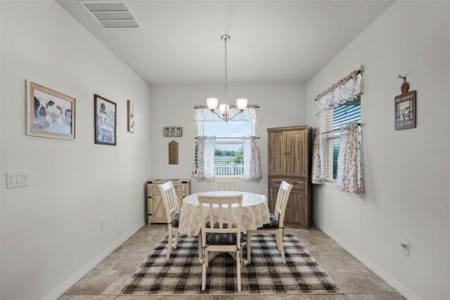 1951 Partin Terrace Rd, Kissimmee, FL 34744 - dining space featuring a chandelier, baseboards, and light stone finish floors