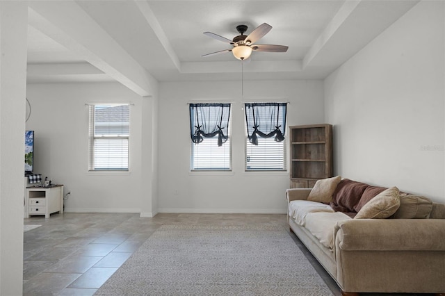 1951 Partin Terrace Rd, Kissimmee, FL 34744 - living room with a tray ceiling, a ceiling fan, light tile patterned flooring, and baseboards