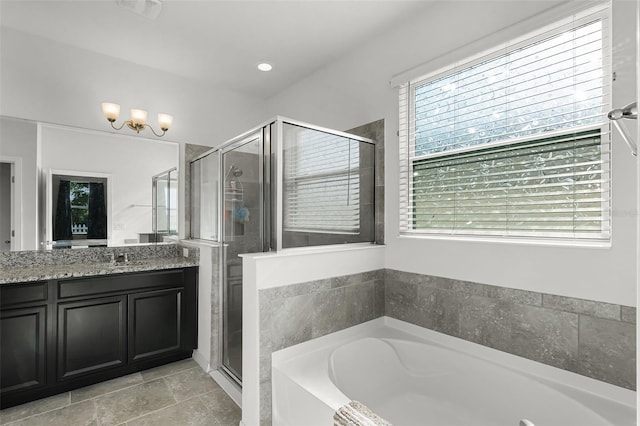 1951 Partin Terrace Rd, Kissimmee, FL 34744 - full bathroom with a garden tub, vanity, a stall shower, and a chandelier