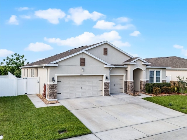 1951 Partin Terrace Rd, Kissimmee, FL 34744 - view of front facade featuring stone siding, stucco siding, concrete driveway, and a garage