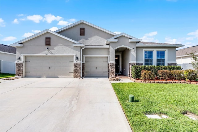 1951 Partin Terrace Rd, Kissimmee, FL 34744 - view of front of house featuring stucco siding, stone siding, an attached garage, and concrete driveway